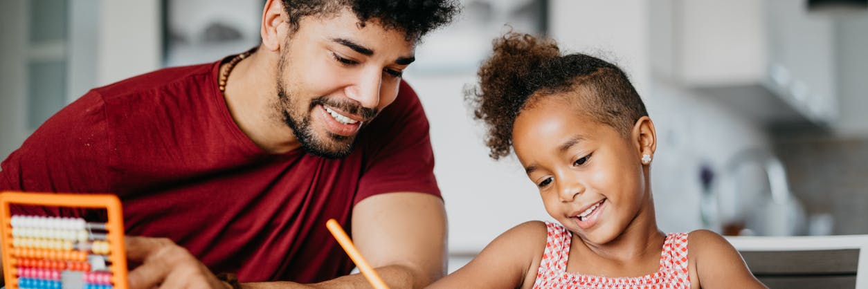 Father helping his child with her math homework.