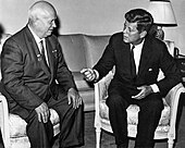 Nikita Khrushchev sitting with hand palms on each knee