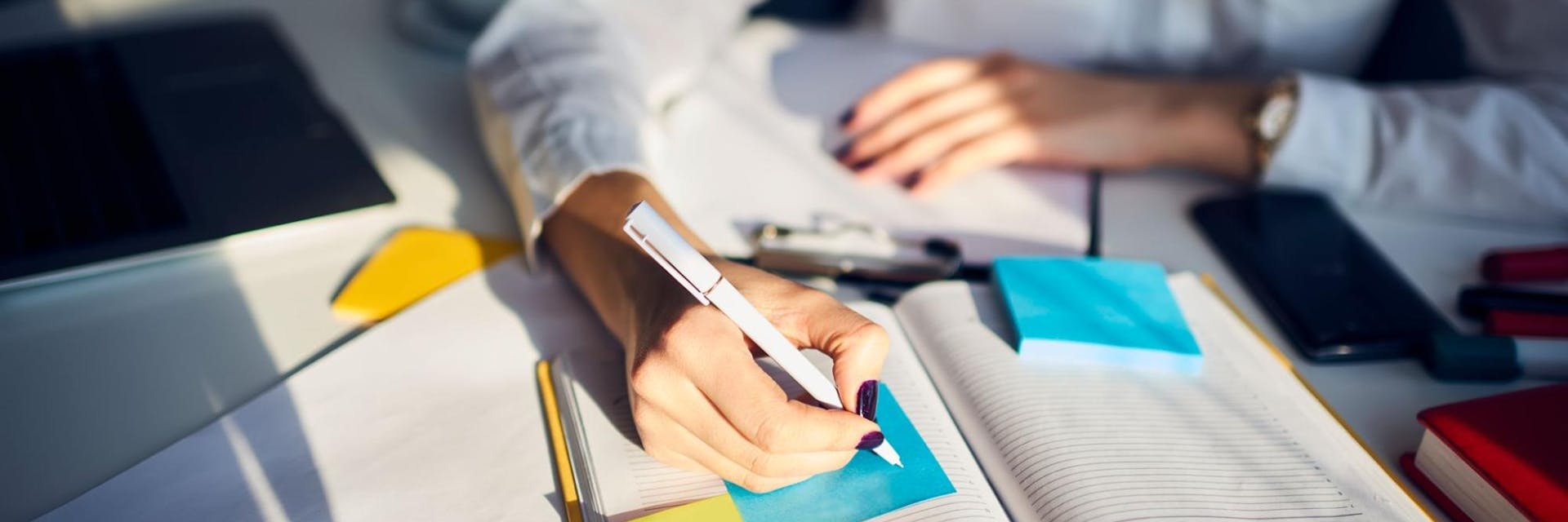 Teacher using a notebook to write a lesson plan