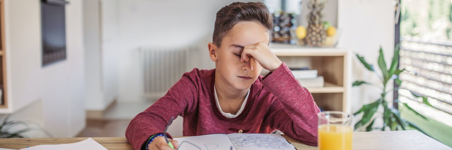 child struggling to study at desk