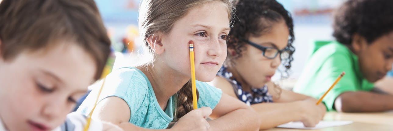 Child sitting at her desk, using mental math practices to help her complete her work. 