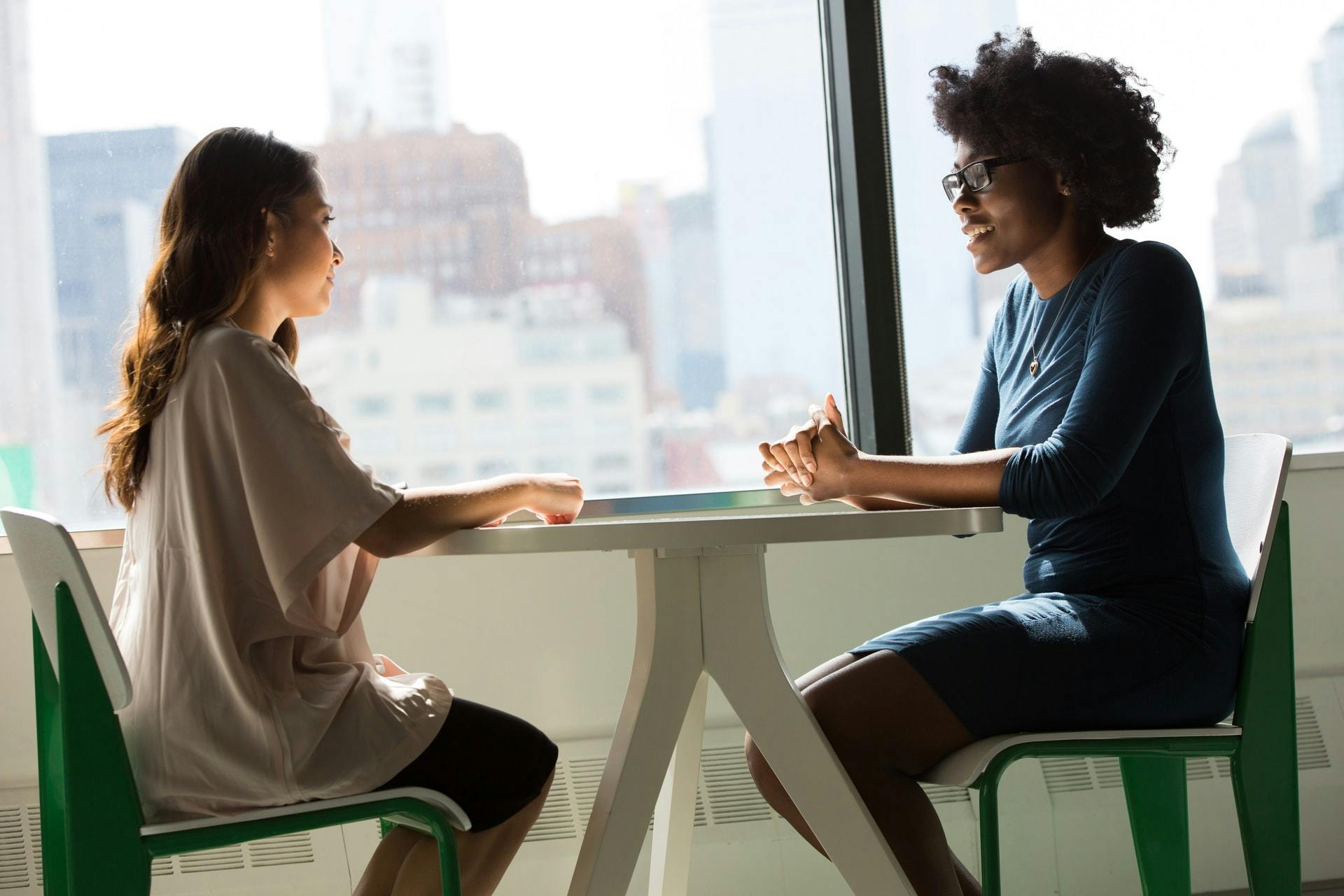 A teacher and a parent talk during a parent teacher conference