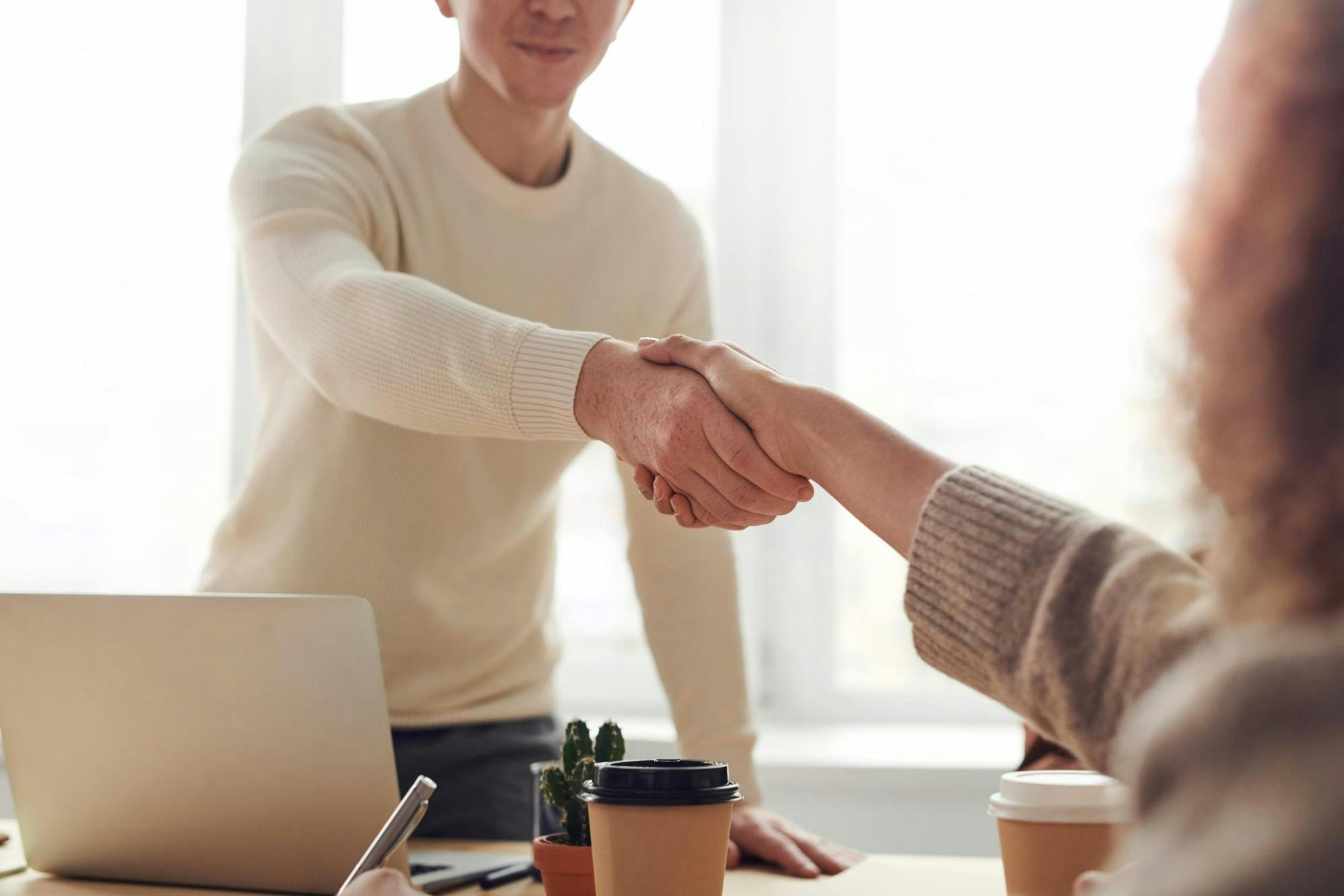 Parent shaking hands with teacher.