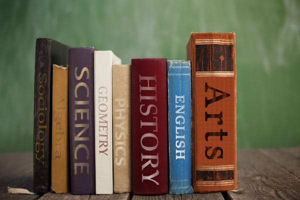 Line of various books with a different school subject on each book's spine.