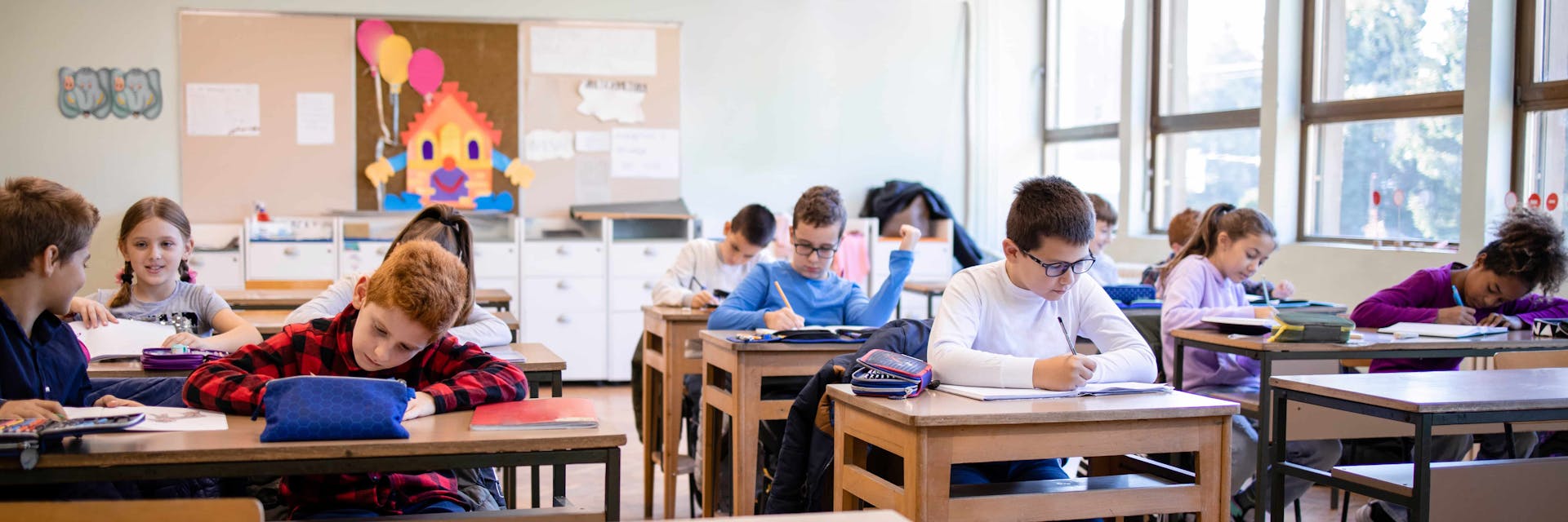 Elementary students taking a summative assessment in a classroom.