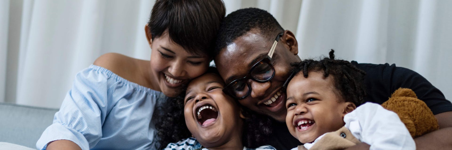 Happy family practicing self care with kids.